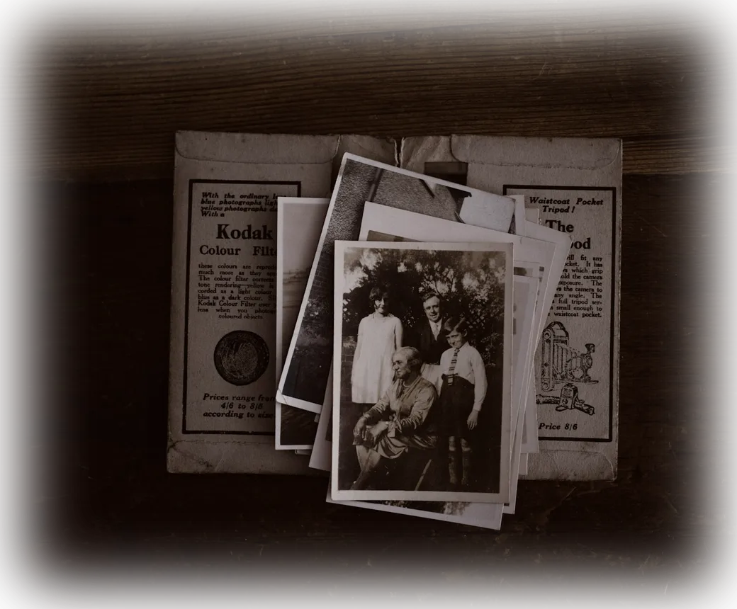 Old family photographs beside archival documents